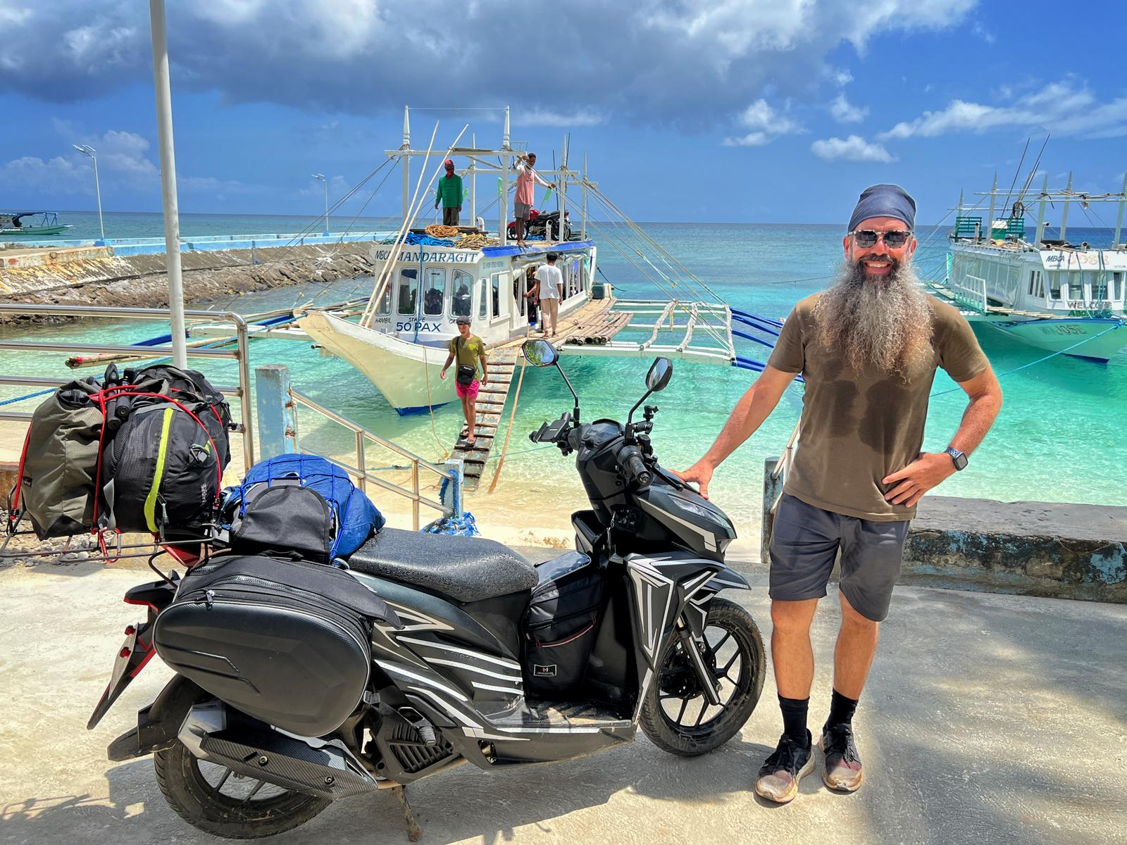 Adrian and his Honda Click 125 scooter at a Philippine port