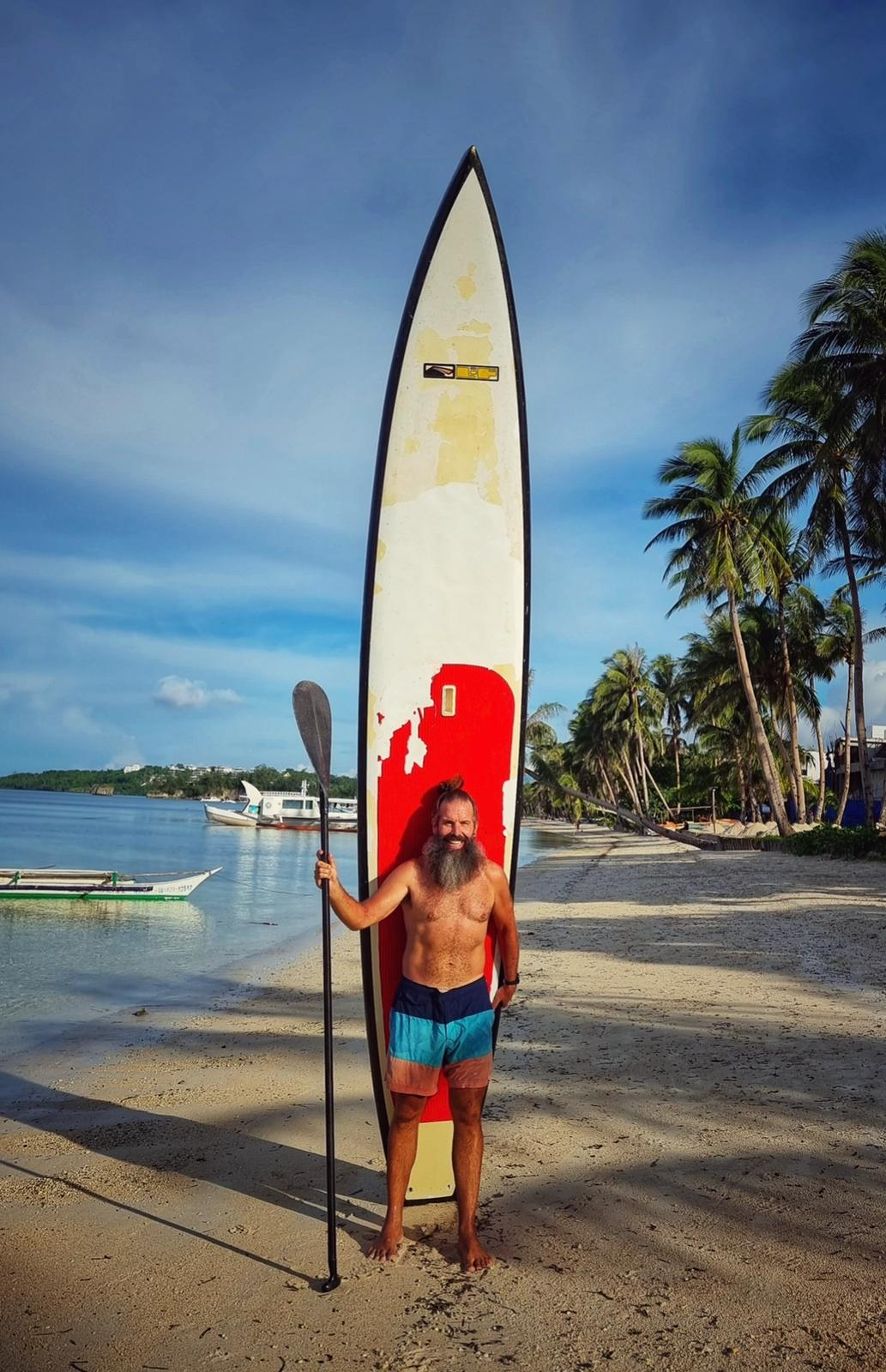 Adrian with his SUP board on Boracay's White Beach
